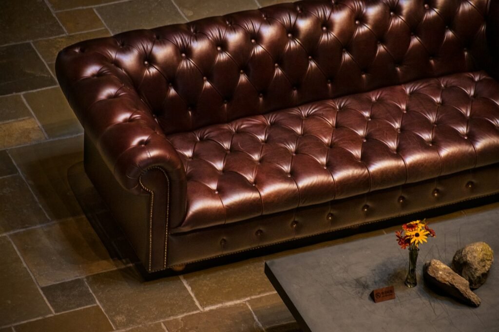 Windsor chesterfield three seater sofa in a dark toned room